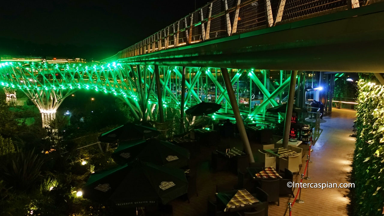 Photo nocturne de l'entrée du restaurant sur le pont Tabiat